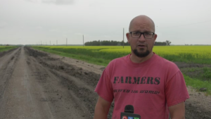 Eric Sabourin works on a farm a few kilometres east of St. Jean Baptiste. He's been forced to use his large truck to commute as the roads around the farm were damaged earlier this year. (Source: Mason DePatie)  