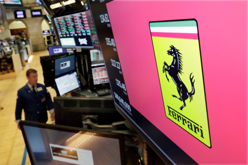 In this Wednesday, Aug. 1, 2018 file photo, the logo for Ferrari is displayed above a trading post on the floor of the New York Stock Exchange. The Luxury Italian automaker raised its 2022 forecast Tuesday after reporting a 22 per cent increase in second-quarter earnings as sales in the Americas surged. (AP Photo/Richard Drew, file)
