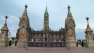 The front gate on Parliament Hill in Ottawa was surrounded by barriers with red "danger" tape Wednesday, Aug. 3, 2022 after an unauthorized vehicle attempted to get onto the hill early in the morning. Ottawa police say charges are pending. (CTV News)