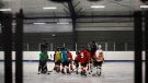 In this Feb. 21, 2019 file photo, teammates gather during a hockey practice at the Scanlon Ice Rink in Philadelphia. (AP Photo/Matt Rourke, File)