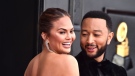 Chrissy Teigen, left, and John Legend arrive at the 64th Annual Grammy Awards at the MGM Grand Garden Arena on Sunday, April 3, 2022, in Las Vegas. (Photo by Jordan Strauss/Invision/AP)