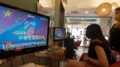 Watching the news at a beauty salon in Taipei, Taiwan, on Aug. 4, 2022. (Chiang Ying-ying / AP)