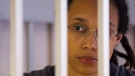 Brittney Griner looks through bars as she listens to the verdict standing in a cage in a courtroom in Khimki just outside Moscow, Russia, on Aug. 4, 2022. (Evgenia Novozhenina / Pool Photo via AP)