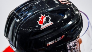 A Hockey Canada logo is visible on the helmet of a national junior team player during a training camp practice in Calgary, Aug. 2, 2022. THE CANADIAN PRESS/Jeff McIntosh