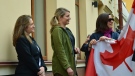 Deputy Prime Minister Chrystia Freeland, Foreign Affairs Minister Melanie Joly and Canada's ambassador to Ukraine Larisa Galadza (left to right) look on as they prepare to raise the flag over the Canadian embassy in Kyiv, Ukraine on Sunday, May 8, 2022. THE CANADIAN PRESS/CBC News/Pool/Murray Brewster