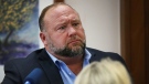 Conspiracy theorist Alex Jones attempts to answer questions about his emails asked by Mark Bankston, lawyer for Neil Heslin and Scarlett Lewis, during trial at the Travis County Courthouse in Austin, Aug. 3, 2022. (Briana Sanchez/Austin American-Statesman via AP, Pool)