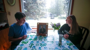 Jill and Derek Lints with a photo of their son Daniel, 17, at their kitchen in Pilot Mound, Manitoba, Wednesday, June 15, 2022. Their son Daniel was sexually exploited online in February and committed suicide because of the interaction. THE CANADIAN PRESS/John Woods