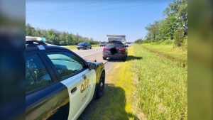 Ontario Provincial Police say the driver of this SUV was using a single rope to secure a mattress and box spring to the top of the vehicle while driving along Hwy. 401 on Saturday. (Ontario Provincial Police/Twitter) 