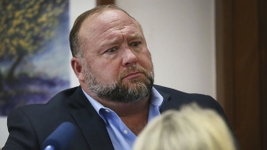 Alex Jones attempts to answer questions about his emails asked by Mark Bankston, lawyer for Neil Heslin and Scarlett Lewis, during trial at the Travis County Courthouse in Austin, Aug. 3, 2022. (Briana Sanchez/Austin American-Statesman via AP, Pool)