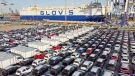 Cars and trucks for export are parked at a port in Yantai in eastern China's Shandong Province on Jan. 4, 2022. China's monthly trade surplus soared to a record US$97.9 billion in June as export growth accelerated following the easing of anti-virus controls that temporarily shut down Shanghai and disrupted trade. (Chinatopix via AP, File)