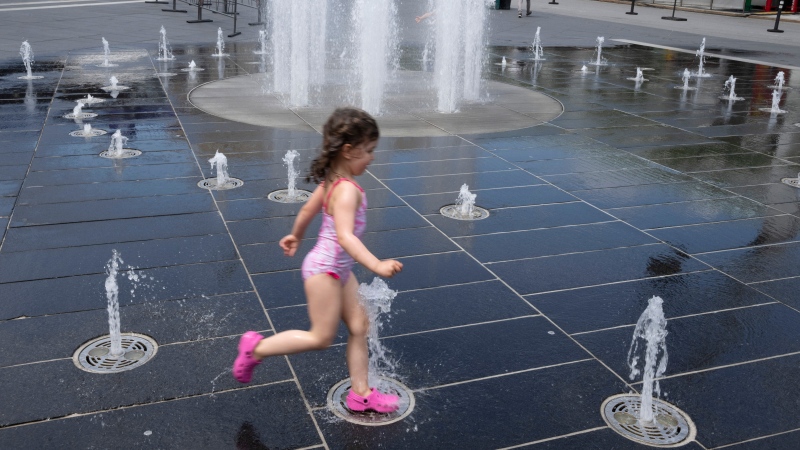 A girl runs through a fountain as temperatures go above 30C, Wednesday, July 20, 2022 in Montreal.THE CANADIAN PRESS/Ryan Remiorz