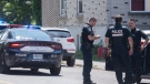 Police officers are shown at an apartment building in Montreal, Sunday, August 7, 2022, where a person apparently lost their life in an altercation with another person. THE CANADIAN PRESS/Graham Hughes