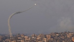 Rockets are launched from Gaza towards Israel, over Gaza City, Aug. 7, 2022. (AP Photo/Adel Hana)