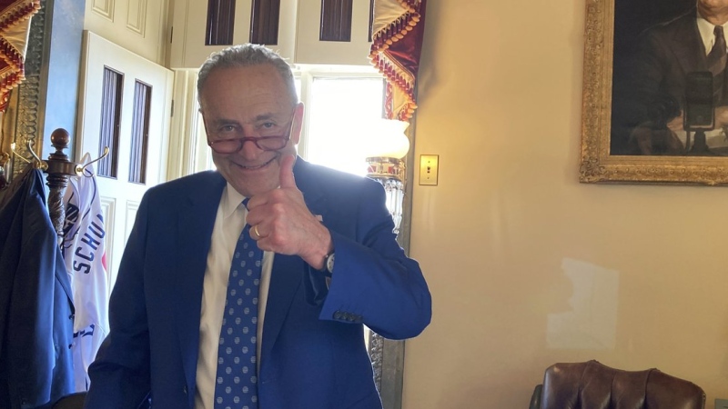 U.S. Sen. Chuck Schumer, D-N.Y., gives a thumbs-up in his office after the Senate approved the Democrats' big election-year economic package, in Washington, Aug. 7, 2022. (AP Photo/Lisa Mascaro)