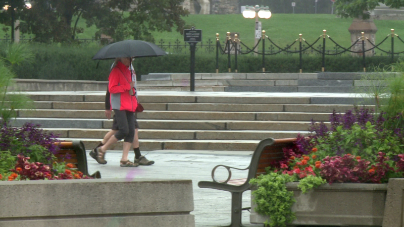 Pedestrians walk in the rain in downtown Ottawa on Monday, Aug. 8, 2022. (Jim O'Grady/CTV Viewer)