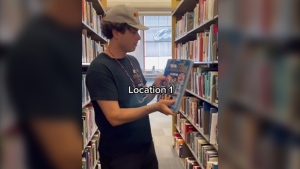 Arkells lead singer Max Kerman hides a ticket for the band's upcoming Vancouver show inside a book at the Vancouver Public Library. (Instagram) 