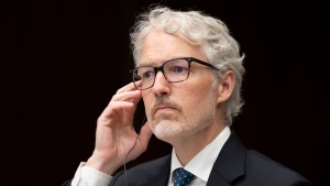 Privacy Commissioner of Canada Philippe Dufresne tests his translation aid as he waits to appear before the Standing Committee on Access to Information, Privacy and Ethics, Aug. 8, 2022 in Ottawa. THE CANADIAN PRESS/Adrian Wyld