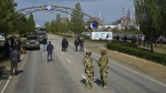 Russian servicemen stand on the road toward the Zaporizhzhia Nuclear Power Station in territory under Russian military control, southeastern Ukraine, May 1, 2022. (AP Photo)