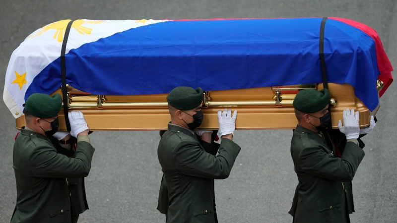 Soldiers carry the flag-draped casket of the late former Philippine President Fidel Ramos during his state funeral at the Heroes' Cemetery in Taguig, Philippines on Tuesday Aug. 9, 2022. Ramos was laid to rest in a state funeral Tuesday, hailed as an ex-general, who backed then helped oust a dictatorship and became a defender of democracy and can-do reformist in his poverty-wracked Asian country. (AP Photo/Aaron Favila)