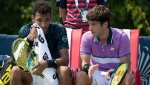 Quebec's Felix Auger-Aliassime, left, and Alexis Galarneau speak while on break of play against Russia's Karen Khachanov and Andrey Rublev during Men's National Bank Open doubles tennis action in Toronto on Monday, Aug., 9, 2021. THE CANADIAN PRESS/Christopher Katsarov