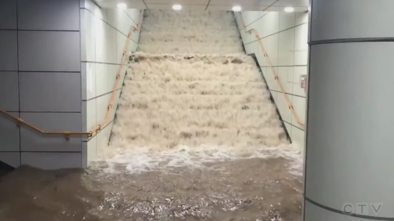 Water pours down stairs in Seoul subway station