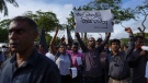 Trade union and civil society activists led by leftists' People Liberation Front shout slogans denouncing president Ranil Wickremesinghe in Colombo, Sri Lanka, Tuesday, Aug. 9, 2022.