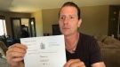 Greg Marentette holds the Ontario Court of Appeal dismissal of Samantha Roberts motion to argue for custody of a dog named Lemmy in Windsor, Ont. on Tuesday, Aug. 9 2022. (Michelle Maluske/CTV News Windsor)