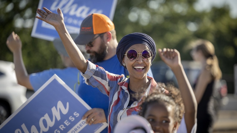 U.S. Rep. Ilhan Omar waves to passersby for support during a voter engagement event on the corner of Broadway and Central Avenues in Minneapolis, Aug. 9, 2022. (Elizabeth Flores/Star Tribune via AP)