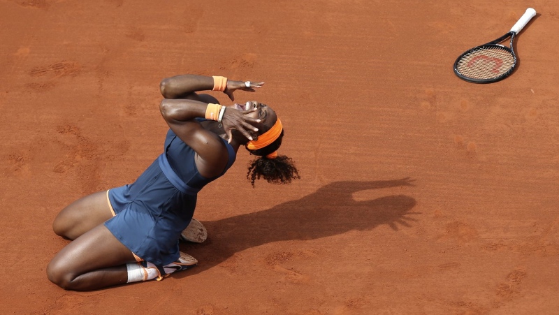 Serena Williams celebrates as she defeats Maria Sharapova during their women's tennis final match at the French Open at Roland Garros stadium, June 8, 2013 in Paris. (AP Photo/David Vincent)