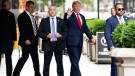 Former U.S. President Donald Trump waves as he departs Trump Tower in New York, on Aug. 10, 2022. (Julia Nikhinson / AP)