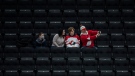 Fans take a selfie as they watch United States take on Finland during first period IIHF World Junior Hockey Championship exhibition action in Edmonton on Thursday, Dec. 23, 2021. THE CANADIAN PRESS/Jason Franson