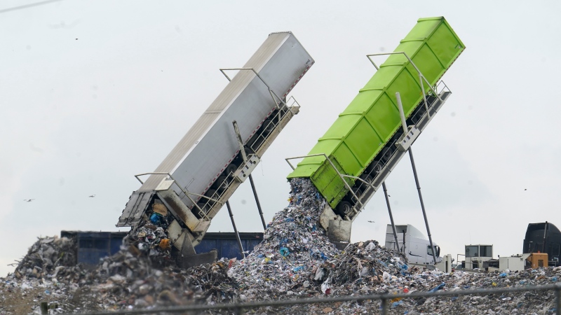 Garbage is off loaded into the Pine Tree Acres Landfill in Lenox Township, Mich., Thursday, July 28, 2022. (AP Photo/Paul Sancya)