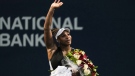 Serena Williams leaves the court carrying flowers and waving to fans after her defeat against Belinda Bencic, of Switzerland, during the National Bank Open tennis tournament in Toronto on Wednesday, Aug. 10, 2022. THE CANADIAN PRESS/Chris Young