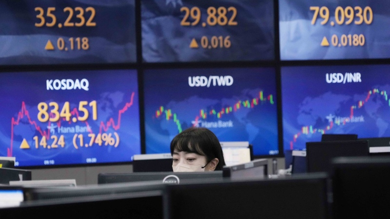 A currency trader watches monitors at the foreign exchange dealing room of the KEB Hana Bank headquarters in Seoul, South Korea, Aug. 11, 2022. (AP Photo/Ahn Young-joon)