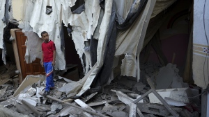 Mohammad Arada looks at the rubble of his family house after it was destroyed by an Israeli airstrike, in Rafah refugee camp, southern Gaza Strip, Aug. 8, 2022. (AP Photo/Adel Hana)