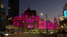 The Flinders Street railway station in Melbourne glowed pink, Aug. 9, 2022, in memory of Olivia Newton-John, who is one Australia's most-loved celebrities. (Reuters)