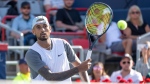 Nick Kyrgios of Australia approaches the net to return to Daniil Medvedev of Russia during the second round of play at the National Bank Open tennis tournament, Aug. 10, 2022, in Montreal. THE CANADIAN PRESS/Paul Chiasson
