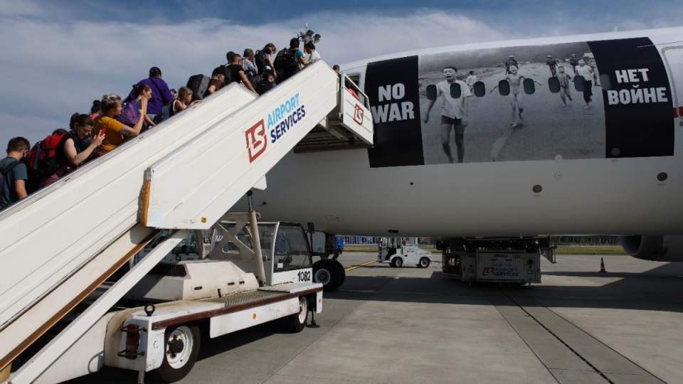 Ukrainian refugees in Poland board plane to Canada