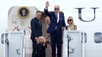 U.S. President Joe Biden, centre, waves as he is joined by, from left, son Hunter Biden, grandson Beau Biden, first lady Jill Biden, and daughter-in-law Melissa Cohen, on the steps of Air Force One at Andrews Air Force Base, Md., on Aug. 10, 2022. (Susan Walsh / AP) 