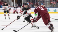 Canada's Connor Bedard (16) makes a move past Latvia's Rihards Simanovics (3) during second period IIHF World Junior Hockey Championship action in Edmonton on Wednesday, August 10, 2022. THE CANADIAN PRESS/Jason Franson