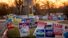 The sun rises over campaign signs at a polling location at the Carver Branch Library on Texas Primary Election Day on Tuesday March 1, 2022 in Austin, Texas. (Jay Janner/Austin American-Statesman via AP)