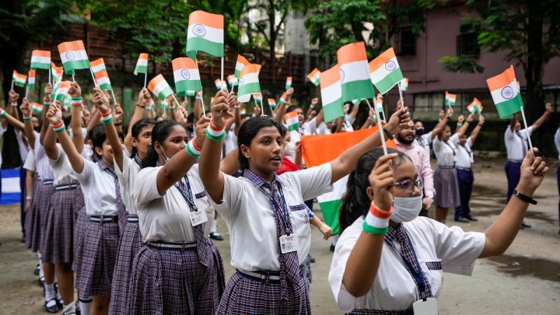 School students wave the Indian tricolour flag during preparations for Independence Day celebrations in Kolkata, India, Aug. 12, 2022. India will celebrate its 75th Independence Day on Aug. 15. (AP Photo/Bikas Das)