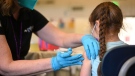 A nurse administers the COVID-19 vaccine to a girl in Los Angeles, California, January 19. (Robyn Beck/AFP/Getty Images/CNN)