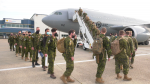 Canadian soldiers board a plane at the Edmonton International Airport to participate in Operation Unifier with the Ukrainian army in England.