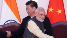 Indian Prime Minister Narendra Modi, front and Chinese President Xi Jinping shake hands with leaders at the BRICS summit in Goa, India, Oct. 16, 2016. (AP Photo/Manish Swarup, File)