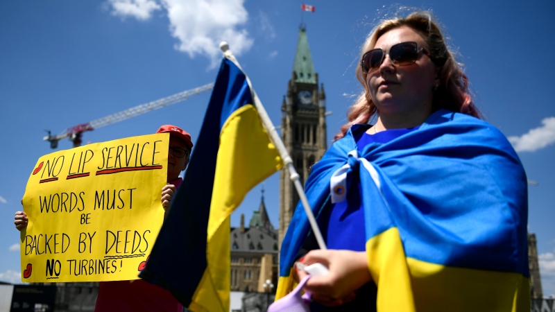 Supporters of Ukraine hold a rally against the Canadian government’s decision to send repaired parts of a Russian natural gas pipeline back to Germany, on Parliament Hill in Ottawa, on Sunday, July 17, 2022. THE CANADIAN PRESS/Justin Tang