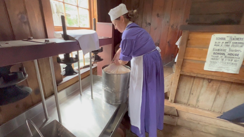 Cheesemaker Kim McLean readying the cheese to be pressed at the Upper Canada Village in Morrisburg, Ont.. (Nate Vandermeer/CTV News Ottawa)