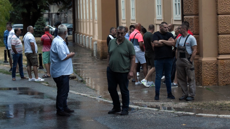 People stand on the site of the attack in Cetinje, some 30 km west of Podgorica, Montenegro, Friday, Aug. 12, 2022. A man went on a shooting rampage in the streets of a western Montenegro city Friday, killing multiple people, before being shot dead by a passerby, officials said. (AP Photo/Risto Bozovic)