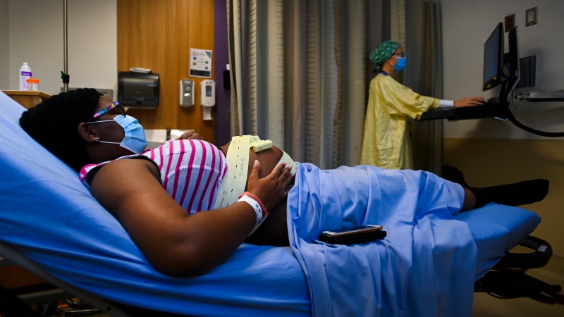 Christal Bryan, left, who is 32 weeks pregnant, receives care from midwife Catherine Cameron at the Humber River Hospital. THE CANADIAN PRESS/Nathan Denette
