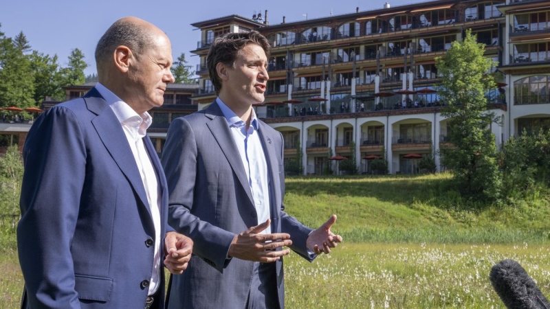 Prime Minister Justin Trudeau and Olaf Scholz, Chancellor of Germany, stop to talk to the media as they take a stroll at the G7 Summit in Schloss Elmau, June 27, 2022. THE CANADIAN PRESS/Paul Chiasson